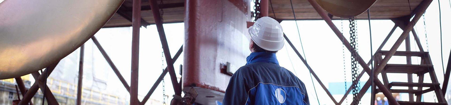 Shipyard worker looks at a steering gear
