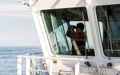 View of the bridge of a ship, man with binoculars